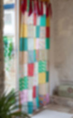 a patchwork curtain hanging in a doorway