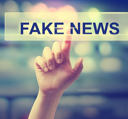Fake News concept with hand pressing a b