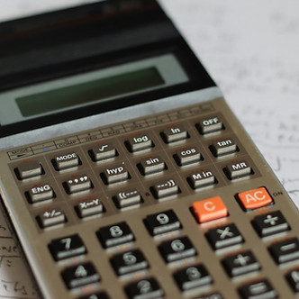 a calculator sitting on top of a piece o