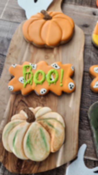Custom Halloween cookies: 'Boo!' and pumpkin designs.