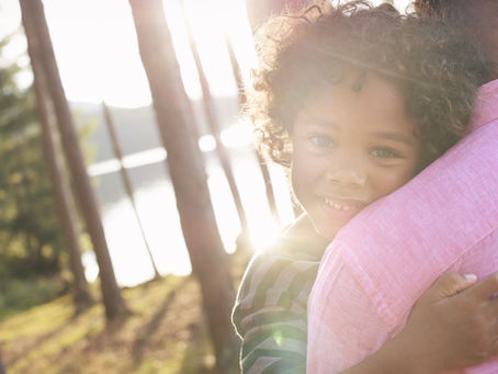 adoptive child and parent hugging