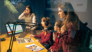 Students recording podcast in studio