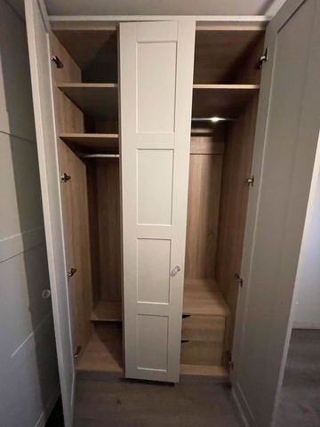 Cream fitted wardrobes with shelves and hanging space