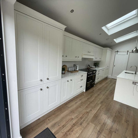 White kitchen cabinets, island, and flooring