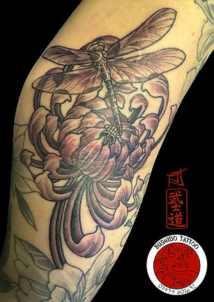 Dragonfly and chrysanthemum tattoo.  Delicate insect tattoos for women.