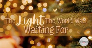 Christmas blog post title image with warm golden bokeh lights and evergreen branches, featuring the text “The Light the World Was Waiting For.” Soft, glowing holiday background with a peaceful, inspirational feel.