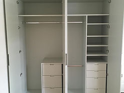 Bespoke fitted off white wardrobe, with 7 varying sizes of drawers, with 3 separate hanging rails and adjustable shelves