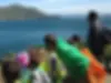 Parents and children on a field trip overlooking the ocean near the Marin Headlands