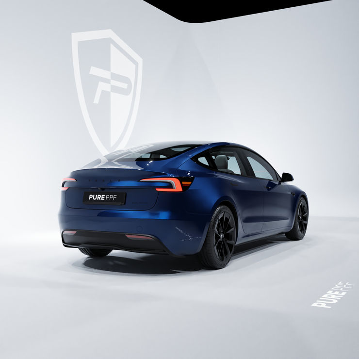 Rear angle view of a Tesla Model 3 wrapped in PurePPF Tanz Blue, showing the rich and vibrant blue shade with a luxurious and intense look.