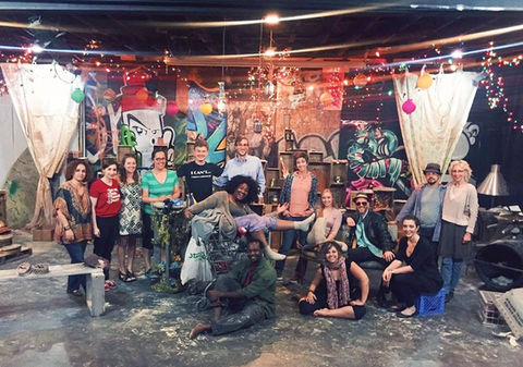 OperaWorks cast group celebrating after performance in festive setting