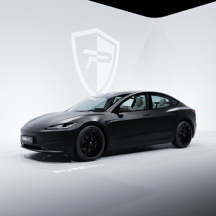 Side view of a Tesla Model 3 wrapped in PurePPF Satin Frozen Black, highlighting the sophisticated and stealthy appearance of the deep black color with a matte finish.