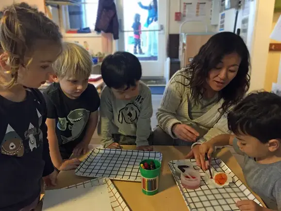 Teachers and children working on a hands-on pattern activity