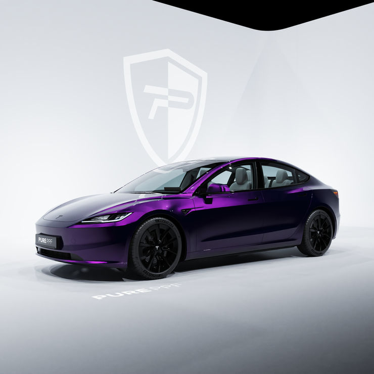 Side view of a Tesla Model 3 wrapped in PurePPF Obsidian Purple, highlighting the powerful and elegant appearance of the luxurious purple color with a gloss black undertone.