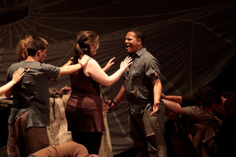 OperaWorks singers performing energetic ensemble scene on stage