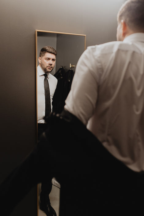 The Maverick Groom getting ready, adjusting jacket.