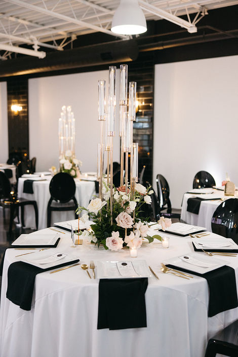 The Maverick Elegant table setting with floral centerpiece and candles.