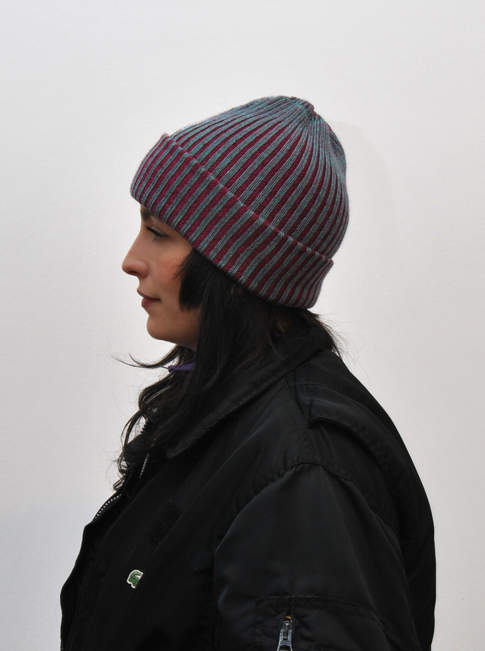 Knitted beanie crafted from repurposed luxury materials, showcasing sustainable fashion design.