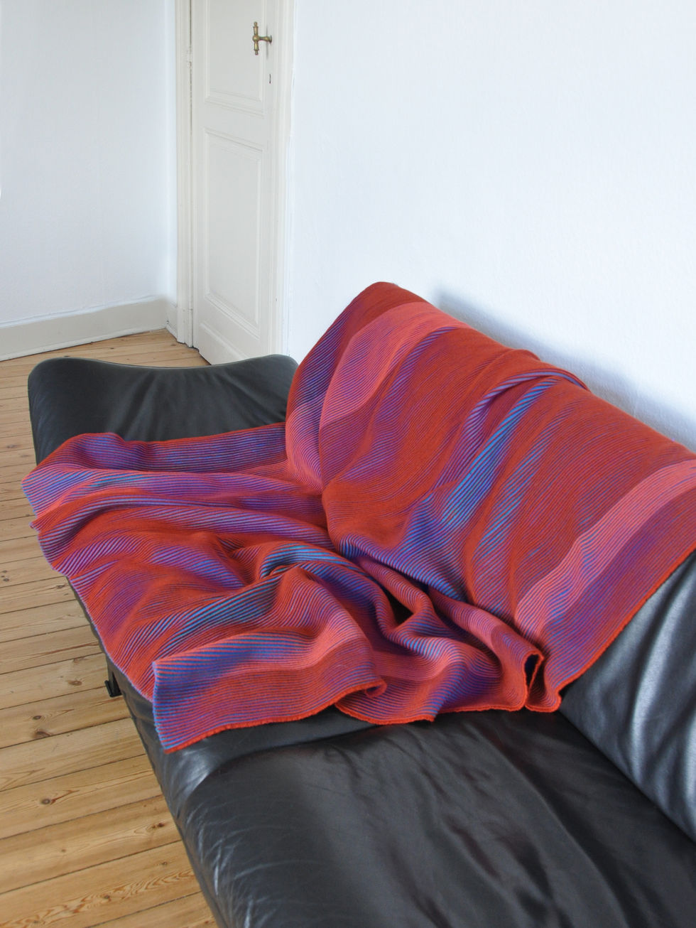 Orange and purple variation displayed on a black couch