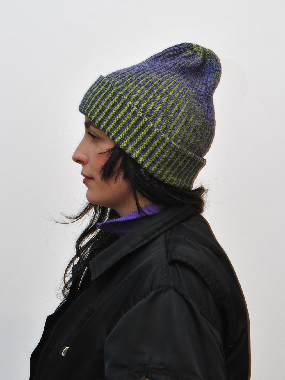 Knitted beanie crafted from repurposed luxury materials, showcasing sustainable fashion design.