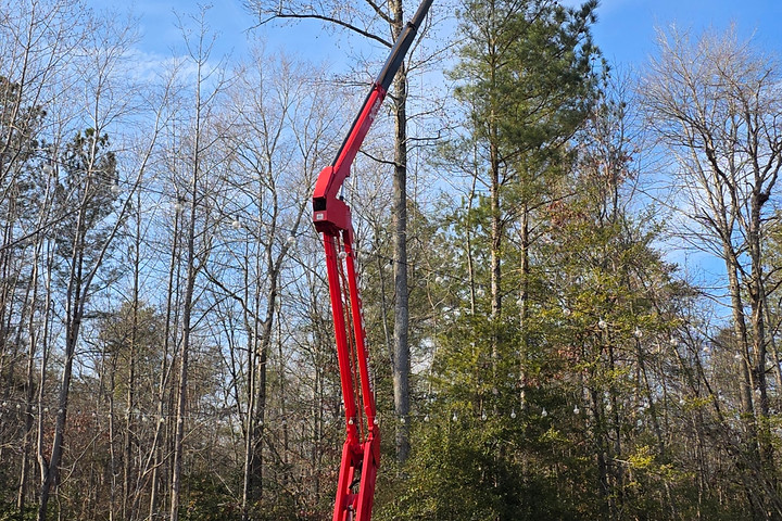 Spider lift in a residential yard showing small footprint of specialized equipment