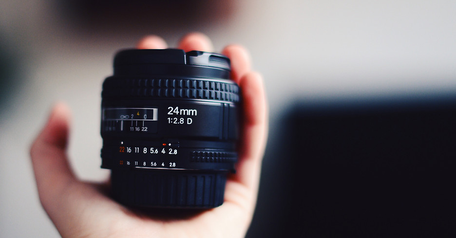 Hand Holding Camera Lens