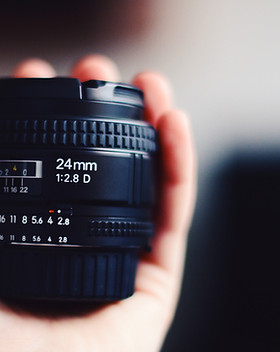 Hand Holding Camera Lens