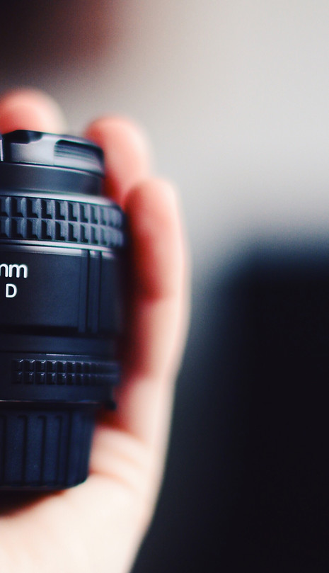 Hand Holding Camera Lens