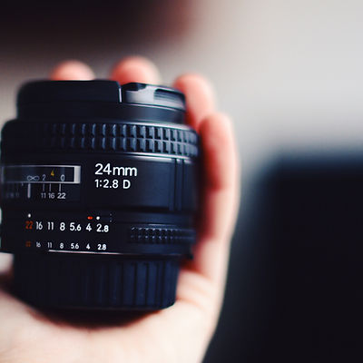 Hand Holding Camera Lens