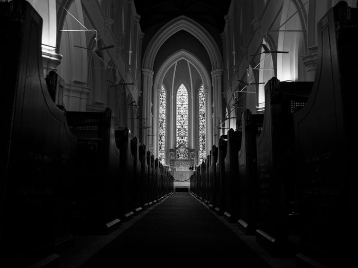 Interior of St Andrew’s Cathedral in Singapore viewed from the central aisle, with rows of wooden pews leading toward the altar beneath arches and stained glass windows, photographed by Gary PWK for the Made In His Image project.