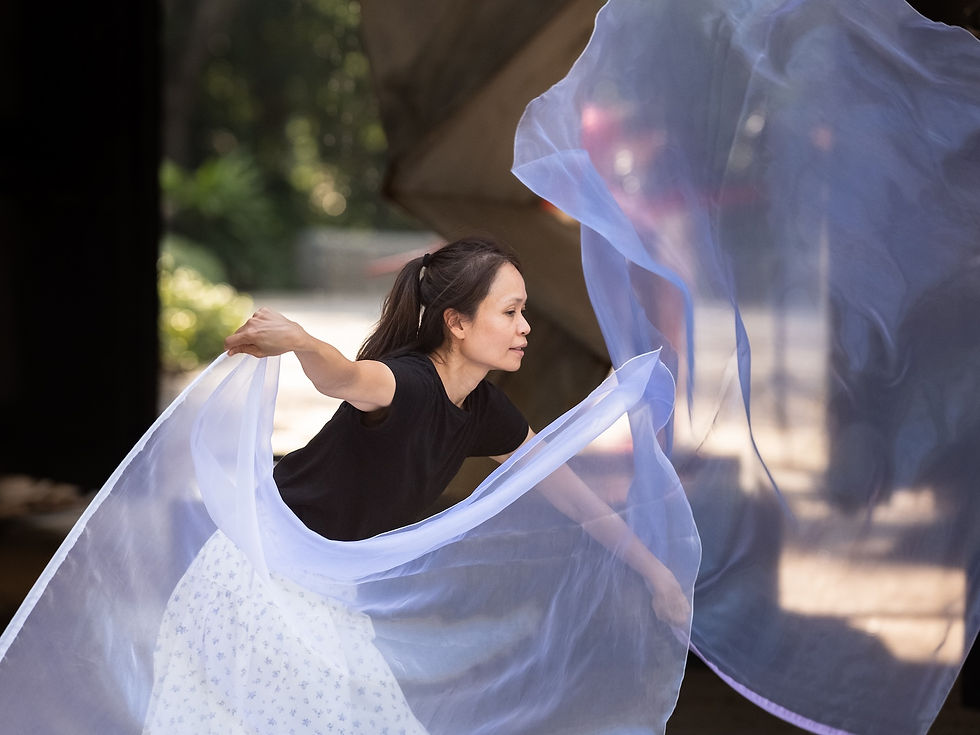 Mirabel moving gracefully with flowing fabric during a dance moment at Fort Canning Park in Singapore, expressing faith and worship through movement during a Made In His Image portrait session.