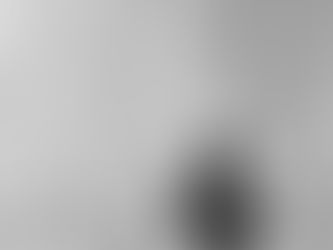 Person standing quietly before the Jewel indoor waterfall in Singapore, symbolising reflection on forgiveness, healing, and the inner work that remains after letting go.