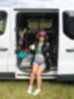 Pregnant Emma sitting in the open side of a campervan