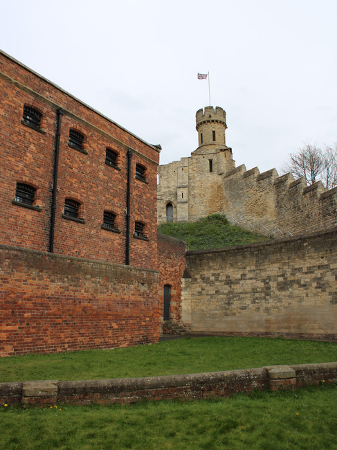 The exterior and exercise yard of the prison at Lincoln Castle. The medieval castle walls can be seen behind.