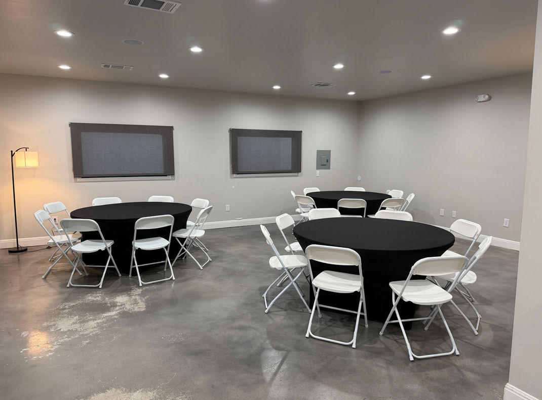 Banquet style tables seating 8 with black table cloths.