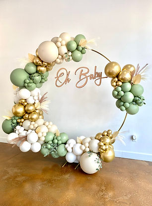 Custom balloon garland on gold hoop backdrop