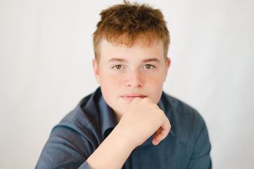 Young man with red hair looking at the camera, a studio portrait