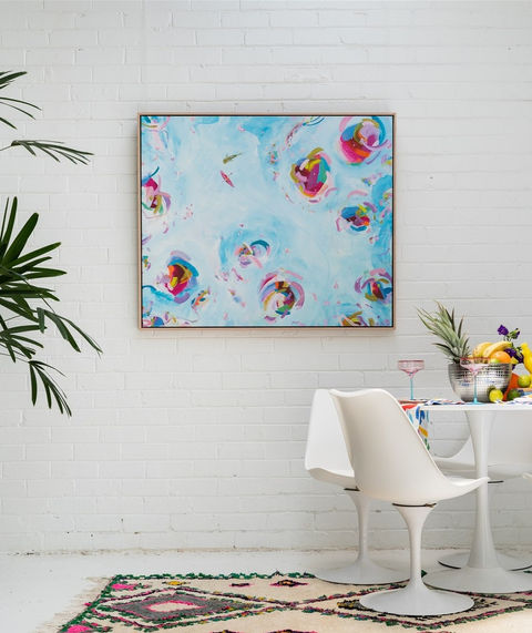 Large blue artwork showing a paddle boarder and whale shark styled in a white interior.