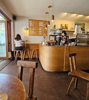 Interior of Pophams bakery café in London with seating designed for conversation and creative meetings