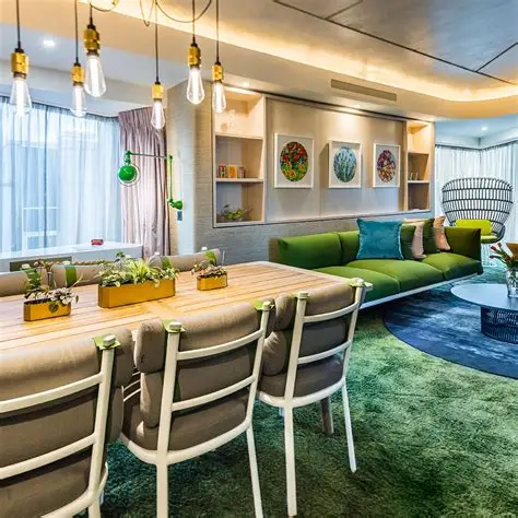 A modern interior of Luca - Clerkenwell, featuring a sleek counter with green seating and warm lighting.