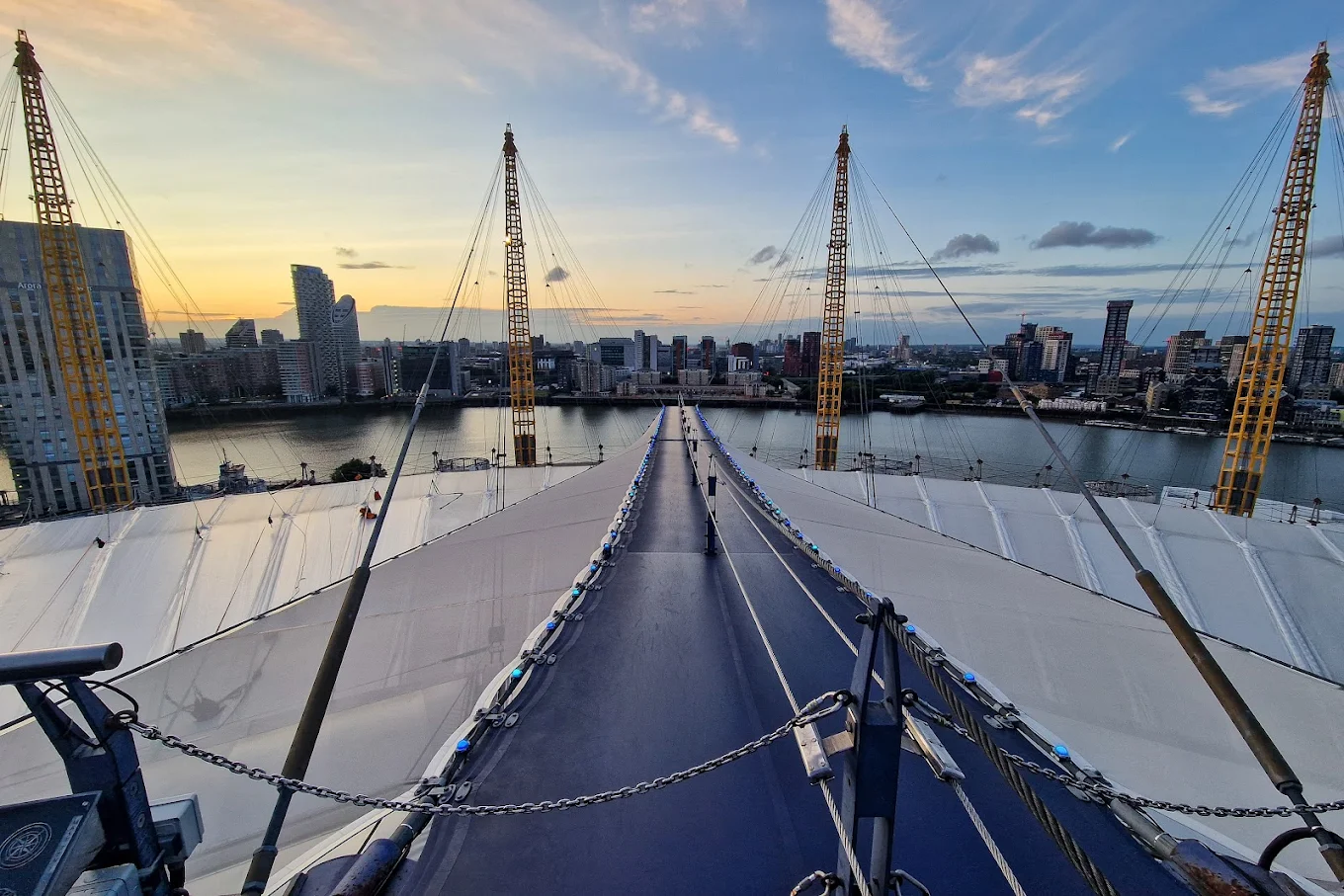 View from the Up at The O2 climb, showing the suspended walkway and London skyline at sunset.