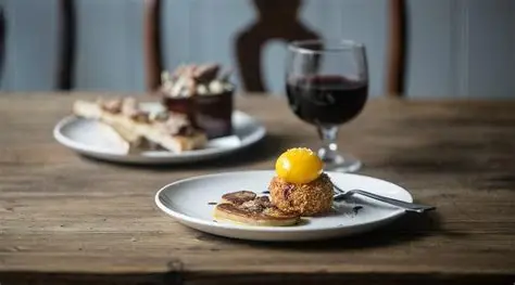 An outdoor dining setup with tables and chairs, surrounded by a cozy atmosphere at Temper.