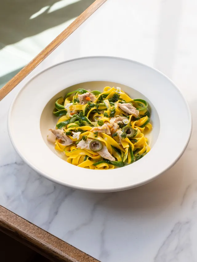A plate of handmade Italian pasta with a creamy sauce, elegantly presented at Luca - Clerkenwell.