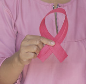 Woman holding a pink ribbon as an awareness of Breast Cancer Day, October, 1, 2020_edited.