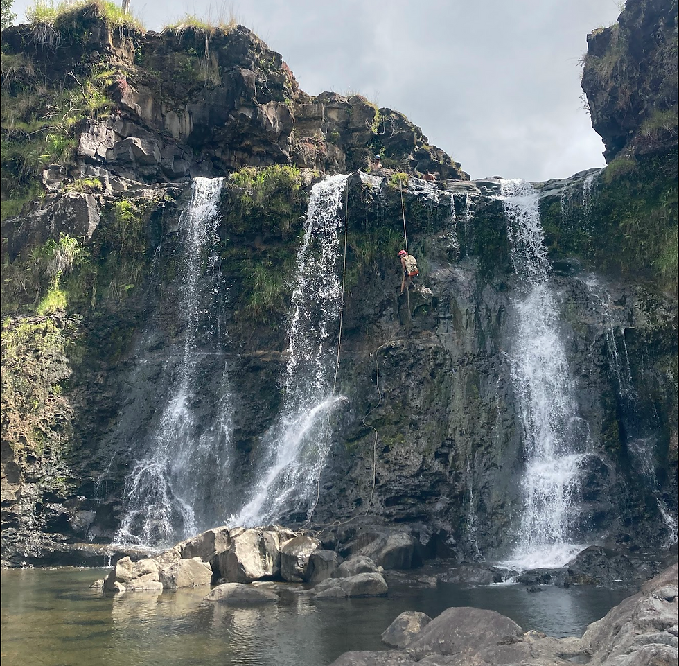 A non-hazardous lava tube with minimal current flowing through made a great natural anchor for this rappel. Photo by Brig Murdock, rig by the author