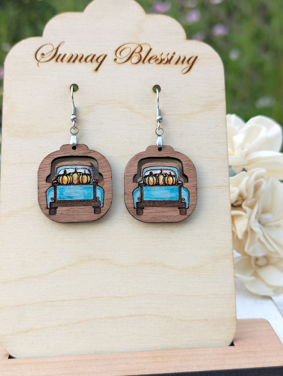 Get ready for fall with these adorable pumpkin truck earrings! Made from lightweight wood, these dangle earrings feature a cl