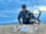 A hunter with his trophy axis.