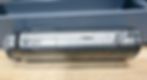 A close-up shot of a screw-on suppressor