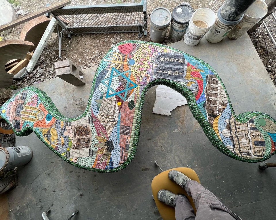 Overhead view of a concrete mosaic bench in artist Oscar Alvarado's studio in San Antonio Texas