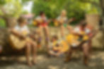 A group of children and a counselor playing acoustic guitars together.