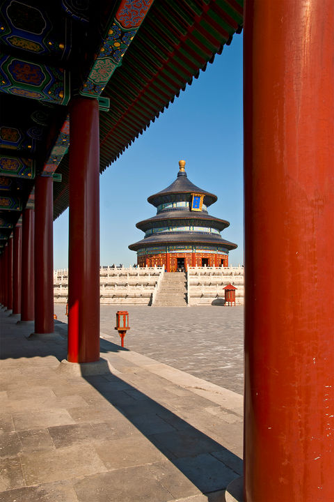 Bright red columns in the foreground looking out on a plaza
